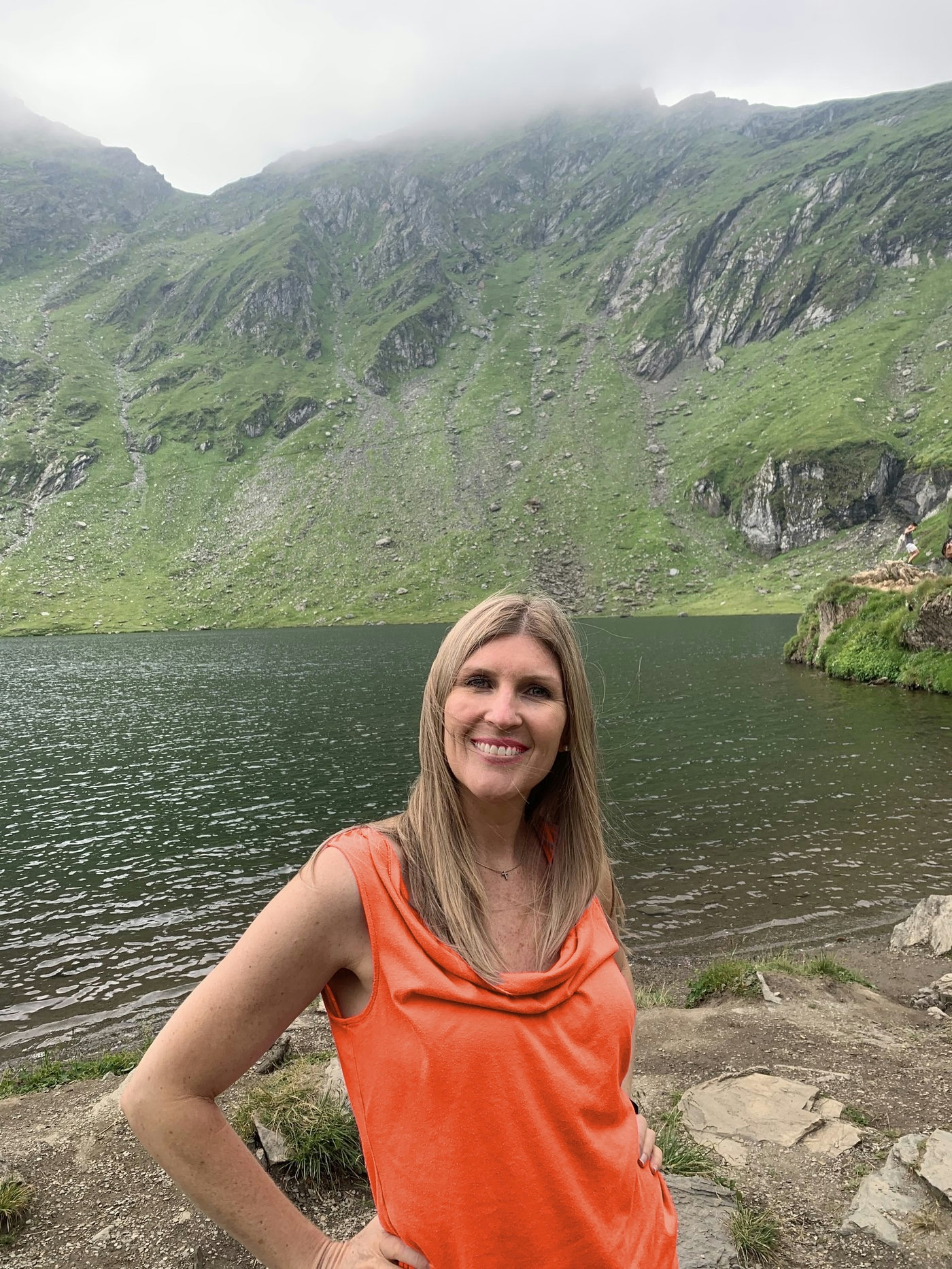 Whitney outdoors in a coral top